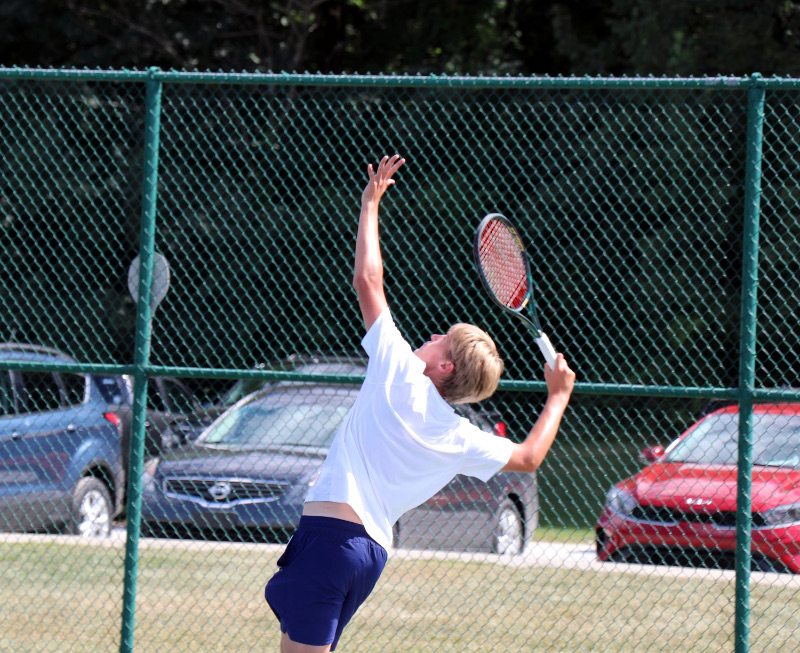 Tennis player goes up for a serve