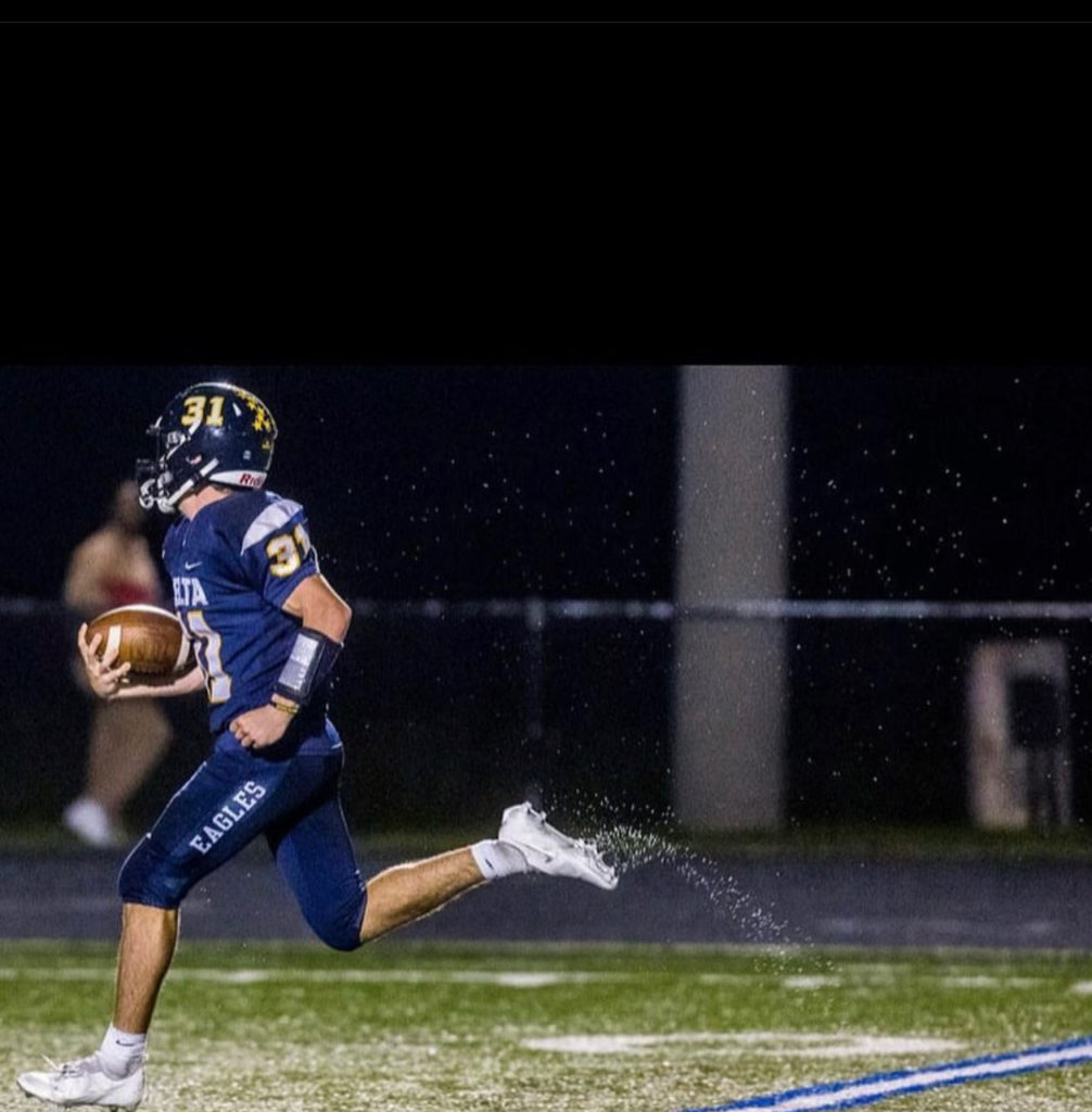 football player running in rain