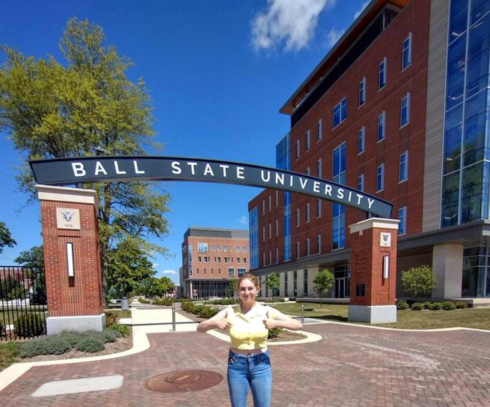 Alisha Fields stands in front of Ball State University entrance.