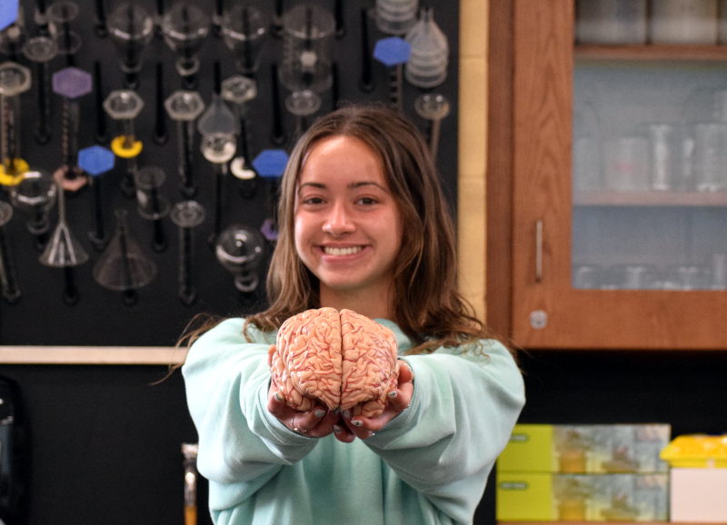 Girl holding brain.