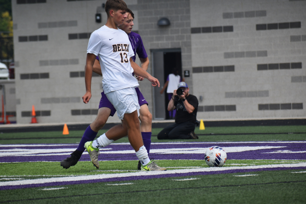 Soccer player kicks ball