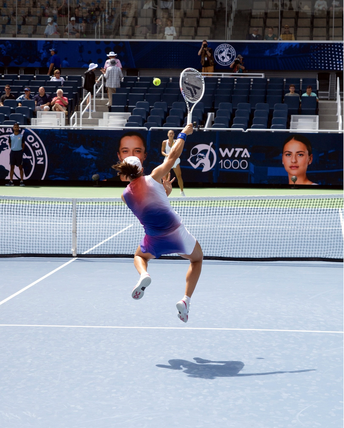 Iga volleys over the net