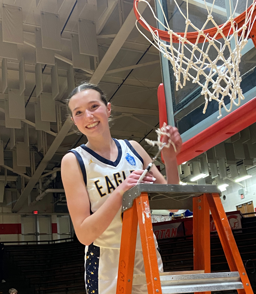 Girl cuts basketball net