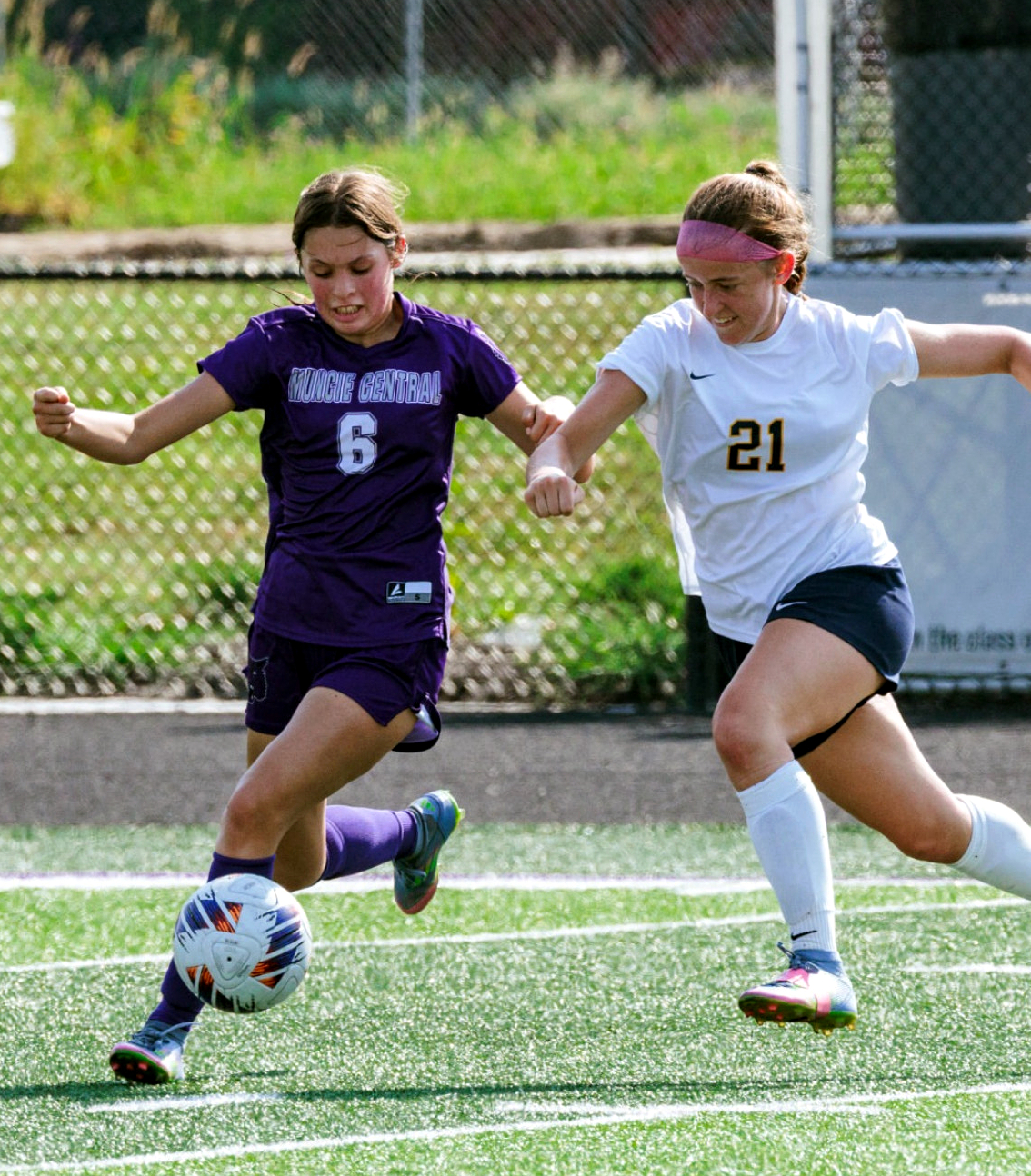 Soccer players chase ball