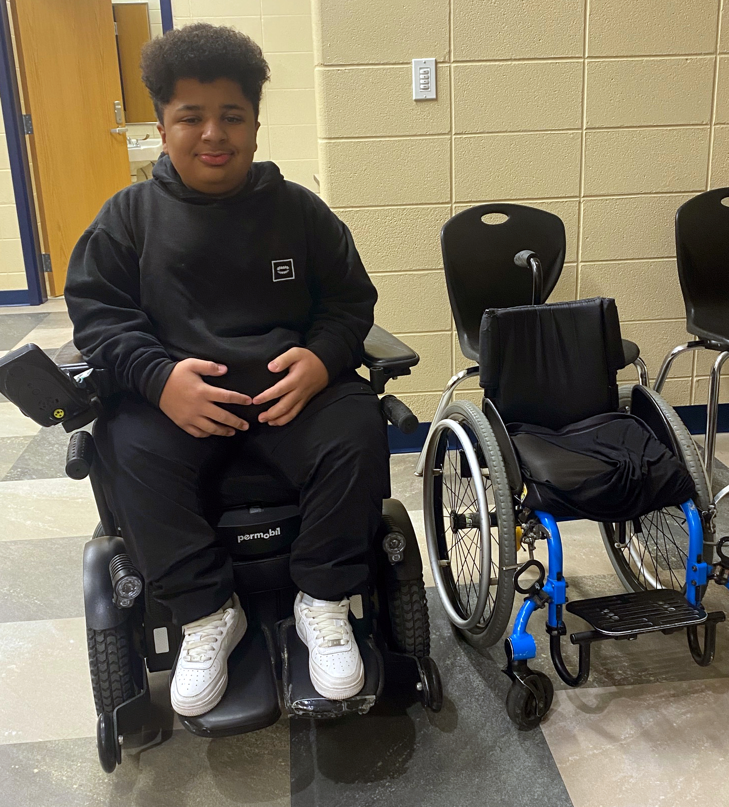 Boy with two wheelchairs