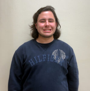 Boy against hallway wall
